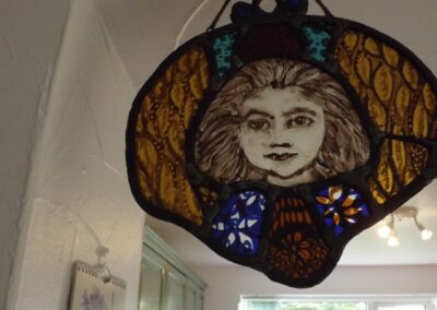 Angel. Leaded stained glass with kiln fired enamel painting. Approximately 25 x 25cm. NFS